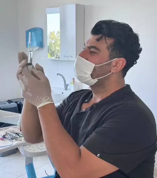 Dt. Cebrail Sağlam preparing an anaesthetic during treatment