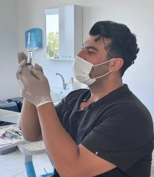 Dt. Cebrail Sağlam preparing an anaesthetic during treatment